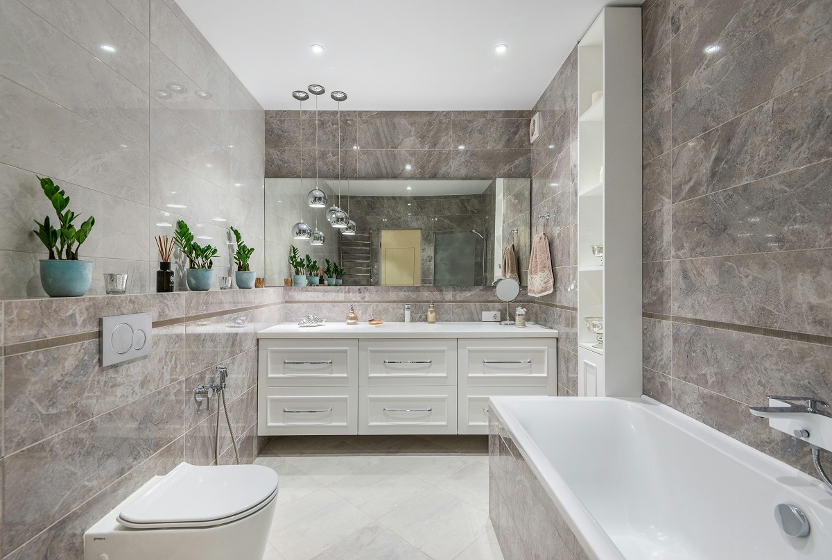 bathroom featuring a modern toilet, bathtub, and vanity