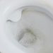 close-up of a toilet with water running in the bowl